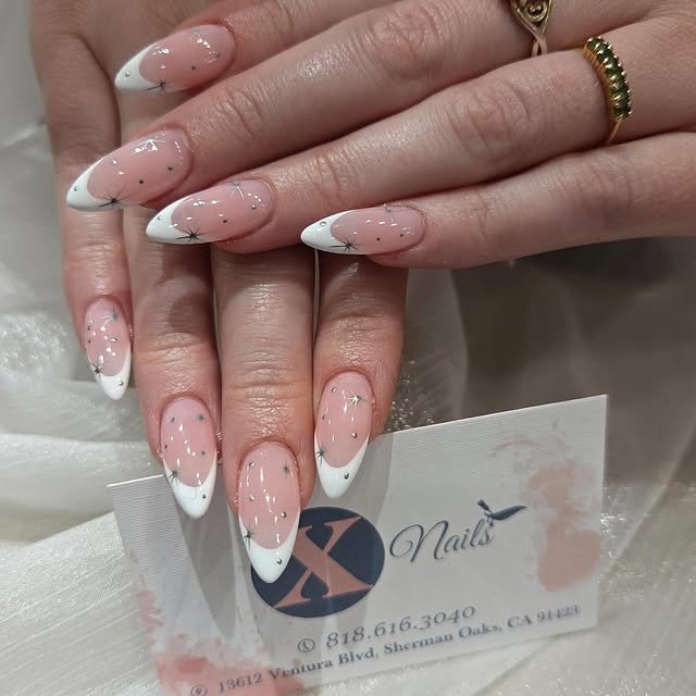 White French tip almond nails with silver star detail